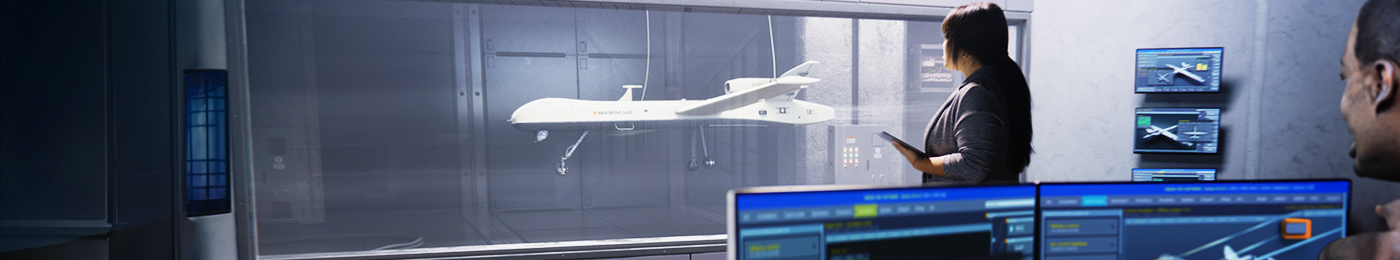 Drone in a wind tunnel watched by engineers