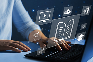 a man sitting at a computer with documents projecting from the screen