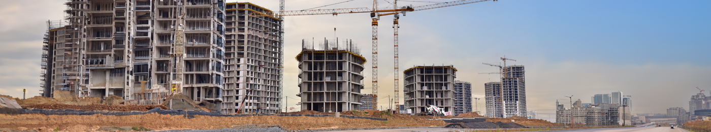 Urban buildings construction site, with large cranes