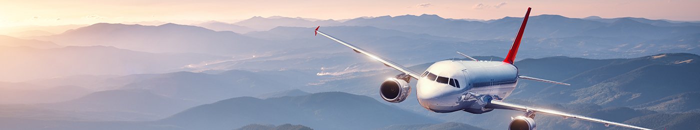 Jet at daybreak over purple mountains