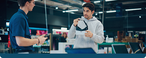 people shopping for electronics in a consumer store