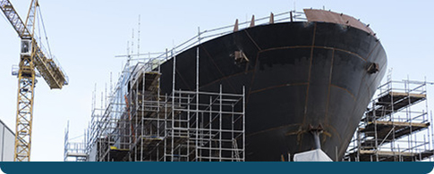 a large ship with scaffolding around it.